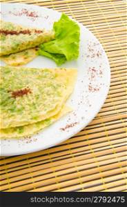 Pancake with herbs in the plate