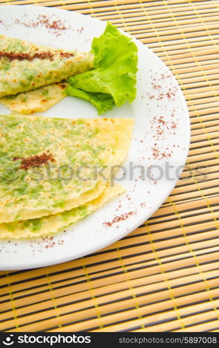 Pancake with herbs in the plate