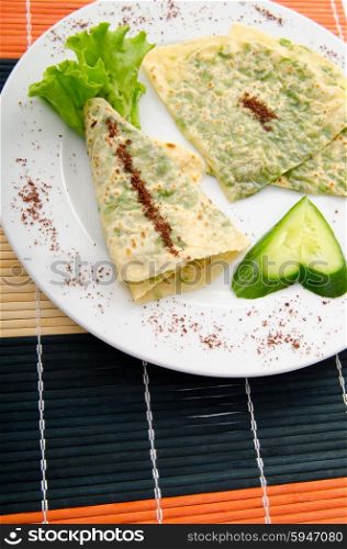 Pancake with herbs in the plate