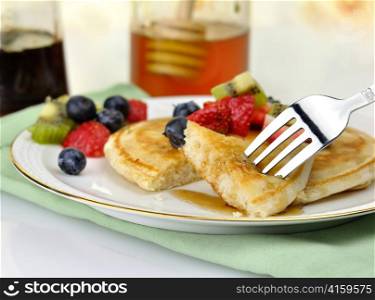 pancake with maple syrup,honey and berries