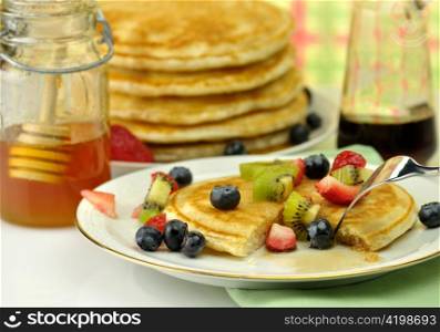 pancake with maple syrup,honey and berries