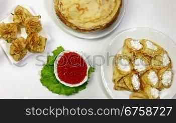 Pancakes and red caviar on dining table - a symbol of the Orthodox Shrove Tuesday. Dolly Shot