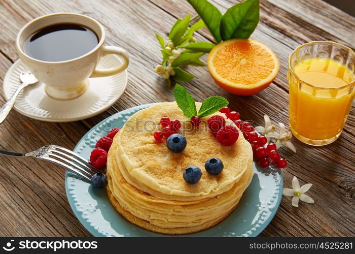 pancakes breakfast syrup coffee and orange juice with berries