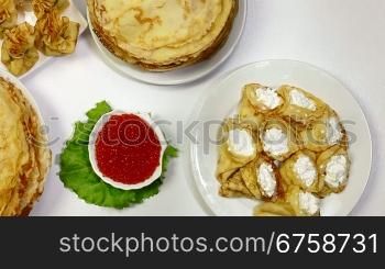 Pancakes on dining table - a symbol of the Orthodox Maslenitsa. Dolly Shot