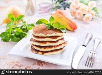 pancakes on plate and on a table