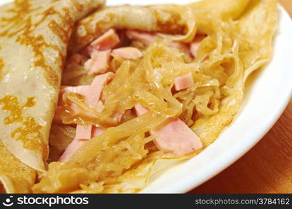 pancakes stuffed ham and cabbage stew. Shallow depth-of-field.