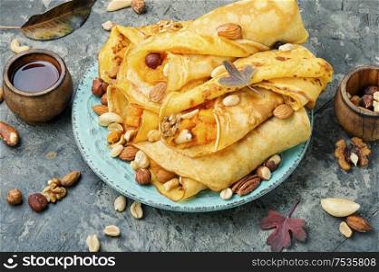Pancakes stuffed with pumpkin and nut.Autumn dessert.Homemade crepes. Pancakes stuffed with pumpkin