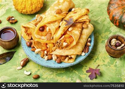 Pancakes stuffed with pumpkin and nut.Autumn dessert. Homemade crepes with pumpkin