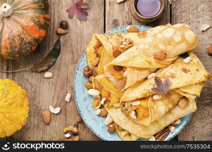 Pancakes stuffed with pumpkin and nut.Autumn food. Pancakes stuffed with pumpkin