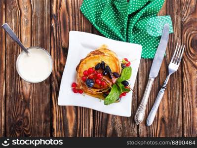 pancakes with berries and on a table