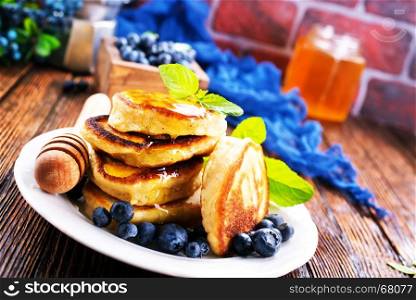 pancakes with blueberry on the plate and on a table
