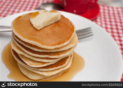 Pancakes With Butter and Warm Maple Syrup On The Table