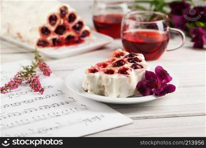 Pancakes with cherries and tea on a white background. Breakfast.