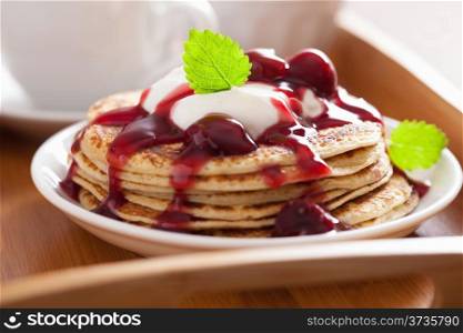 pancakes with cherry jam and cream for breakfast