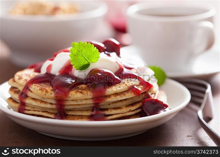 pancakes with cherry jam and cream for breakfast