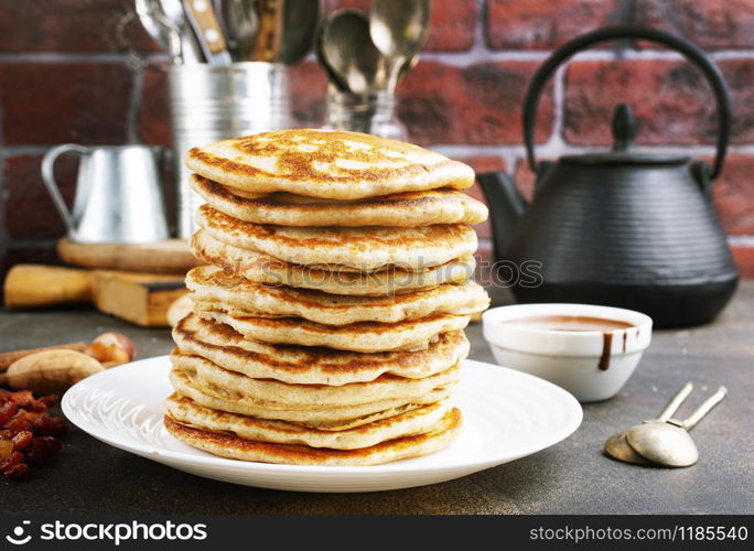 pancakes with chocolate sauce on white plate