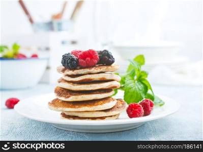 pancakes with fresh berries on plate, stock photo