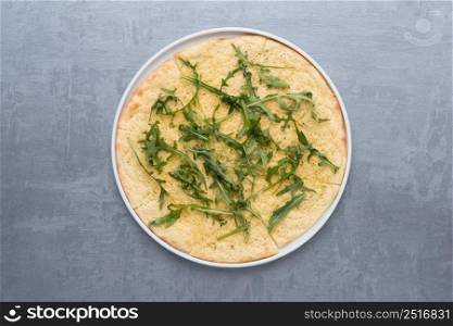 pancakes with greens in a plate on a gray background. the food, the view from the top