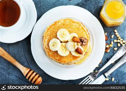 pancakes with honey and nuts on the plate