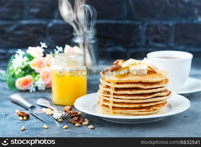 pancakes with honey and nuts on the plate
