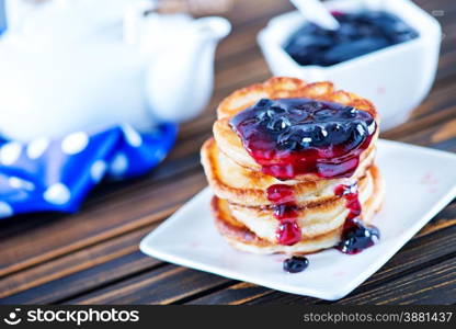 pancakes with jam on plate and on a table