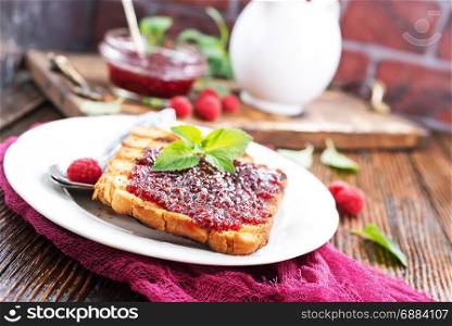 pancakes with jam on plate and on a table