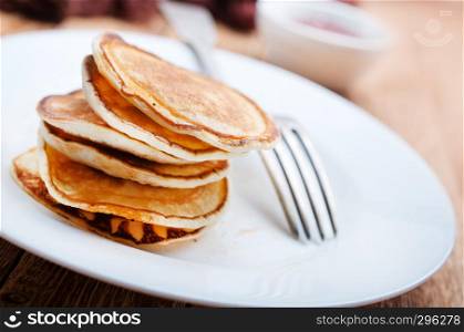 pancakes with jam on plate on a table