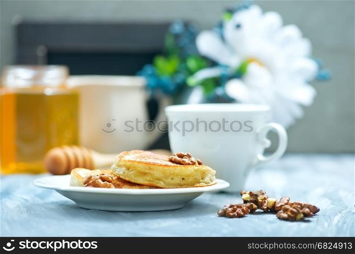 pancakes with nuts and honey on a table