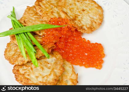 pancakes with red caviar and green onion closeup dish