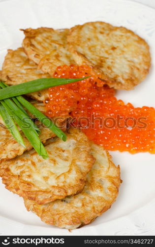 pancakes with red caviar and green onion closeup dish