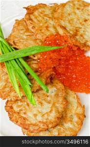 pancakes with red caviar and green onion closeup dish