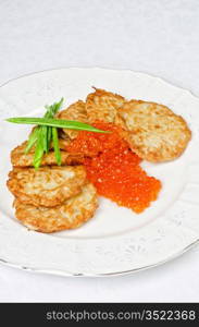 pancakes with red caviar and green onion closeup dish