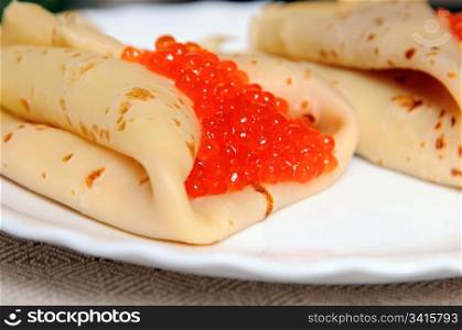 pancakes with red caviar on the plate