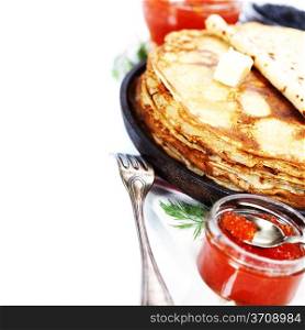 Pancakes with red caviar on white background (traditional russian food)