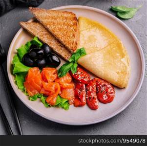 Pancakes with red fish salmon with pepper and olives