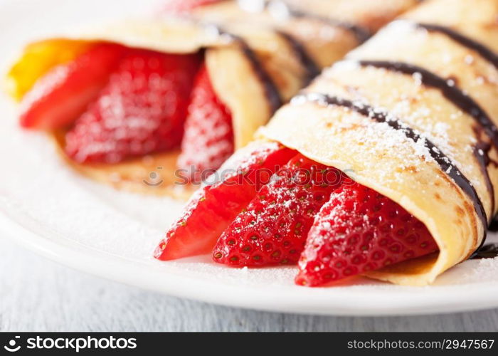 pancakes with strawberry and chocolate sauce