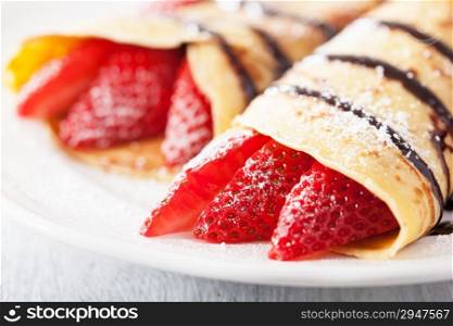 pancakes with strawberry and chocolate sauce