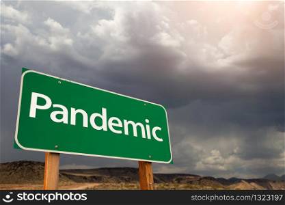 Pandemic Green Road Sign Against Ominous Stormy Cloudy Sky.