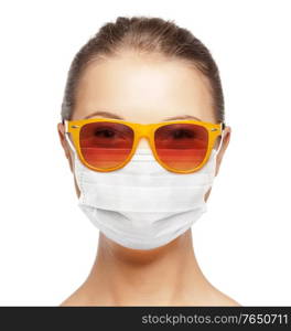 pandemic, health and people concept - portrait of teenage girl in sunglasses wearing medical face mask for protection from virus disease. teenage girl in medical mask and sunglasses