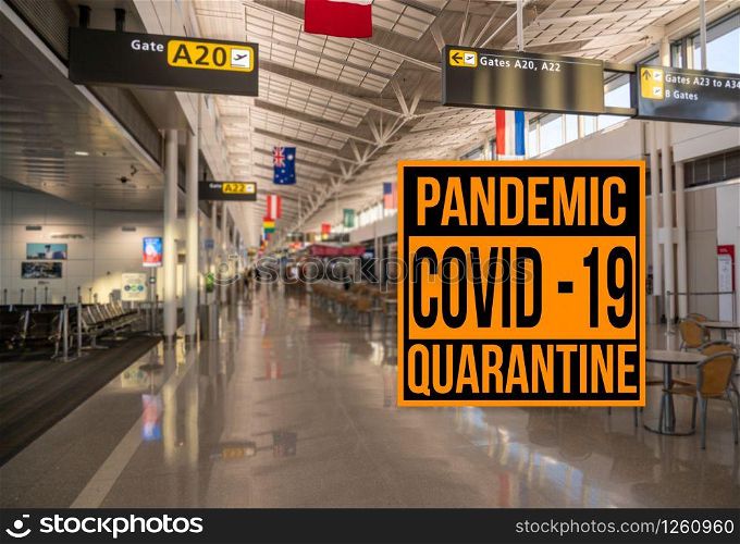 Pandemic sign warning of quarantine due to Covid-19 or corona virus in the USA against background of empty airport terminal. Pandemic sign warning of quarantine due to Covid-19 or corona virus against aiport background