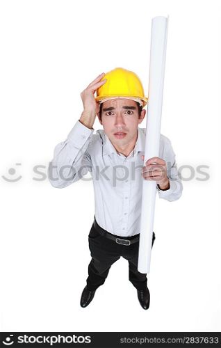 Panicked engineer holding a rolled-up drawing