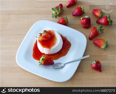 Panna cotta on a plate and wooden board&#xD;&#xA;