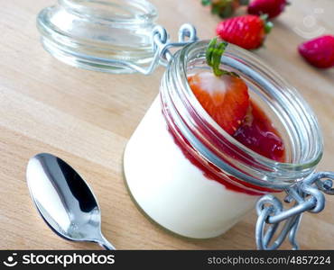 Panna cotta with strawberries in jar&#xD;&#xA;