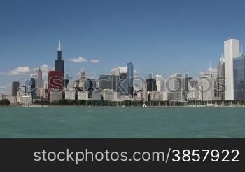 Panning across the Chicago skyline from a moving boat in Lake Michigan on a clear day