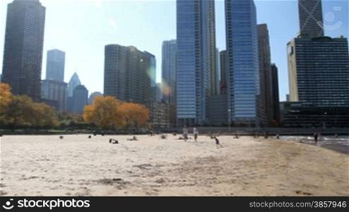 Panning across the sandy beach by Navy Pier, revealing the Chicago skyline along the coast of Lake Michigan