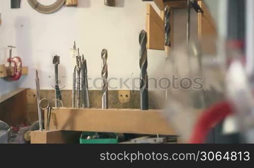 Panning on screwdrivers, rasp, equipment and tools in carpentry workshop
