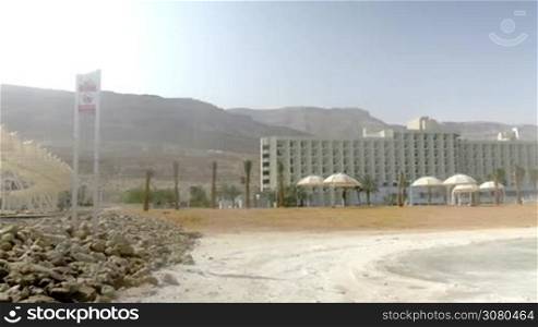 Panning shot of resort with hotel and recreational areas on the shore of Dead Sea, Israel