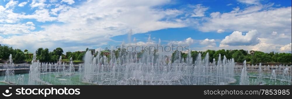 Panorama beautiful fountain against the blue sky with clouds