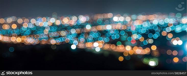 Panorama bokeh of city at night by defocus lighting of building and traffic