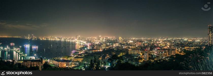 Panorama cityscapes of pattaya in the night with colorful and the city is business growth.